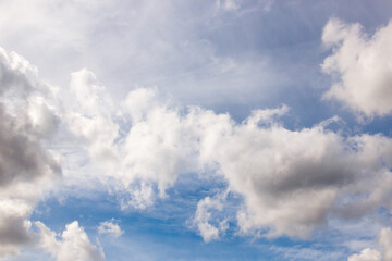 cumulus and high-cumulus clouds of an average tier on blue heavenly space