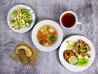 Combo lunch of fish dishes on a gray background