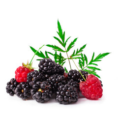 Blackberries and raspberries with leaves isolated on a white background.