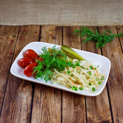Sauerkraut appetizer with pickles and tomatoes