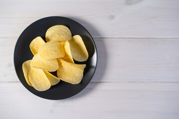 Potato chips on a dark plate