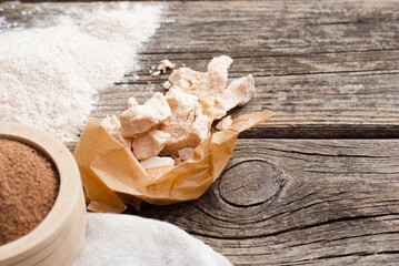 broken yeast cake on wax paper, weathered wood table background