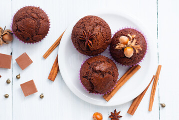 chocolate muffins with hazelnuts on white wooden