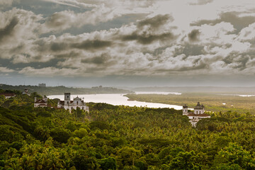 Aeriel view of tropical Landcsape in Goa, India with ancient catholic churches in the foreground