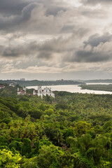 Fototapeta na wymiar Aeriel view of tropical Landcsape in Goa, India with ancient catholic churches in the foreground