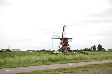Red white wooden seesaw mill in the Doespolder near Hoogmade in South Holland the Netherlands.
