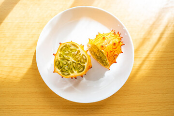 A cut ginseng fruit on the wooden table