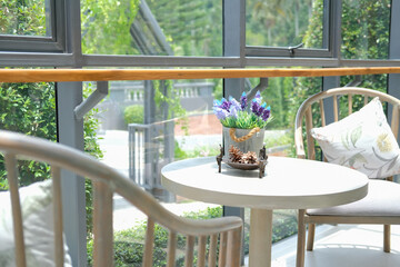 plant flower in metal tin bucket. chair in living room home interior