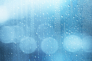 abstract background rain glass / autumn weather raindrops outside the window, cold october wallpaper