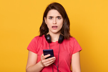 Portrait of astonished girl use cellphone for reading social media notification, being impressed...