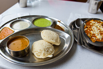 simple traditional indian lunch, a la carte dish, tortillas and sauces, yogurt and chutney, panir butter masala and dahl