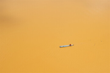 a lone boatman on the yellow river in Kota Bharu in Malaysia