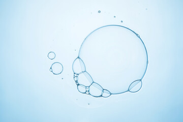 lots of transparent soap bubbles on light blue water