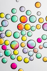 different color water bubbles on white background.