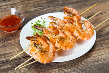 Grilled prawn skewer with sauce