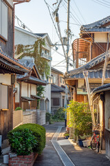 Fototapeta na wymiar Machiya traditional wooden houses in narrow backstreet in old Kyoto, Japan