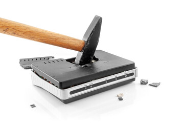 Broken hammer internet router with shrapnel around it on a white background. Internet abandonment...