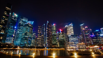Beautiful architecture building skyscraper around marina bay in singapore city at night.
