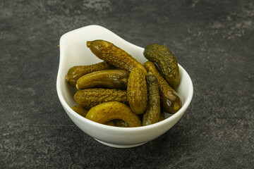 Pickled gherkin in the bowl