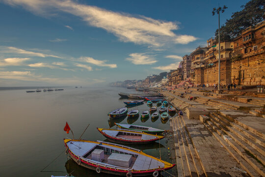 early morning view of famous ghats of varanasi where wooden boats lined up 