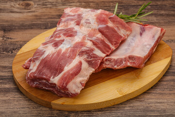 Raw pork ribs served rosemary