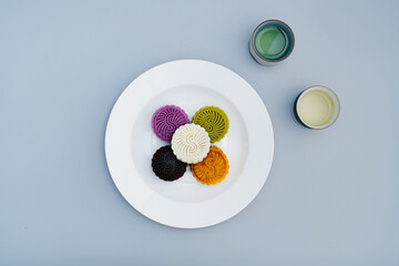 Colorful moon cakes are placed on white plates. Chinese traditional food mid autumn moon cake