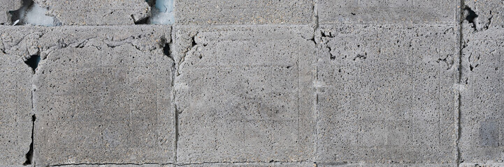 Rough gray texture of the wall with cement in place of old tiles. Wide panoramic texture for background and design.