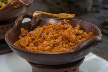 Javanese spicy stew of cattle skin crackers (krecek). typical side dish for gudeg. served in a traditional earthenware wok