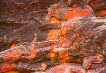 Obraz na płótnie Canvas Textured surface of red stone.