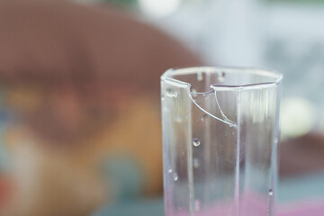 broken glass cup close up, part of the glass is bitten off