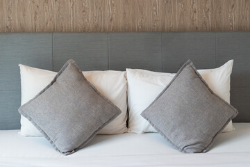 Luxury stacking of pillows on bed.