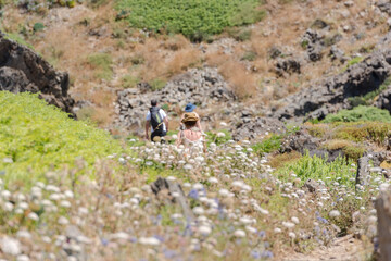 People in  Cap de Creus, natural park. Eastern point of Spain, Girona province, Catalonia. Famous tourist destination in Costa Brava. Sunny summer day with blue sky and clouds
