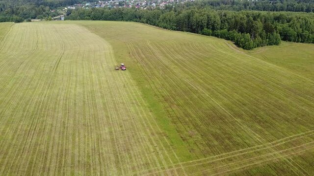 Aerial photography. The work of agricultural machinery on mowing grass for pets