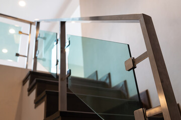 Fototapeta na wymiar Modern minimalist style stairs with brown wooden and steel handrails.