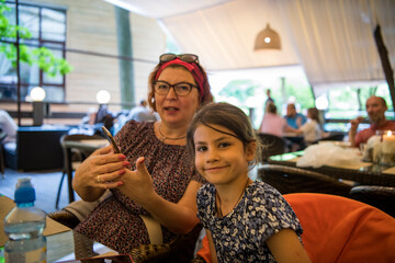 grandmother and granddaughter relaxing on a park together