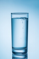 a glass of water with bubble on blue background.