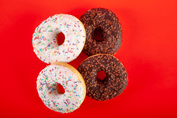 junk food donuts on red background stock photo