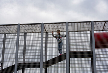 beautiful girl on a playground in a leisure park