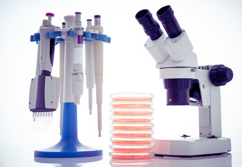microscope, petri dishes and pipette stand by microbiological laboratory
