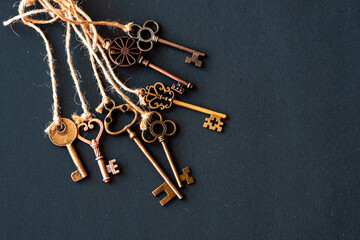 A bunch of different old keys from different locks. Finding the right key, encryption, concept.
