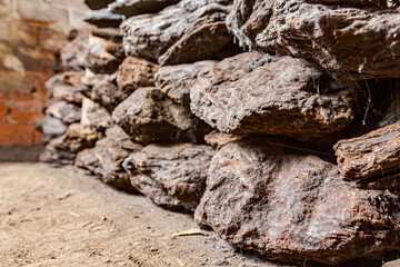 Dry charcoal pile stacked in basement