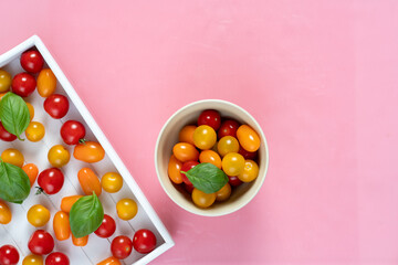 fresh italian cherry tomatoes on the vine in a wooden crate on a white background