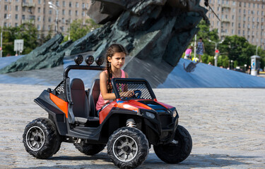 beautiful girl riding an electric car in a park © константин константи