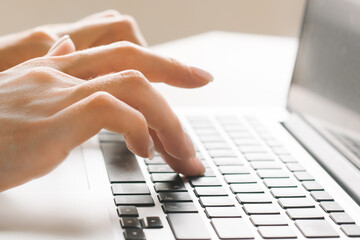Close-Up Of Female Hands Typing Text On The Keyboard Of Laptop Or Computer. High quality photo