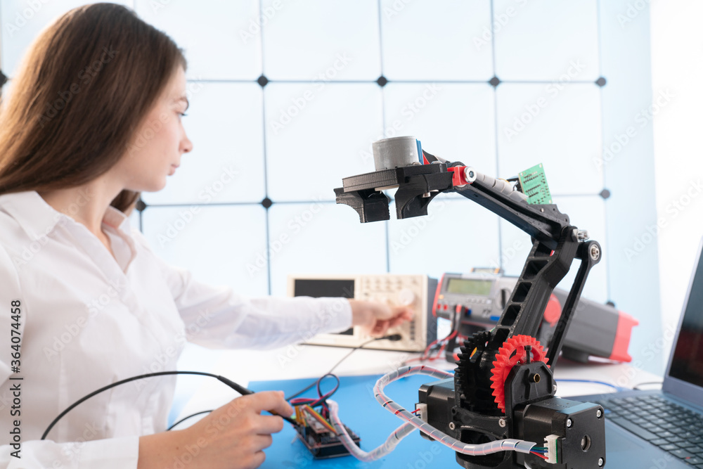 Canvas Prints Woman student with robot model arm