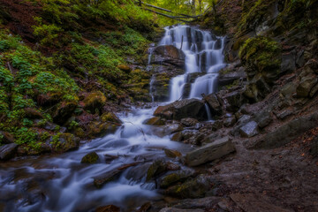 Naklejka na ściany i meble Carpathian waterfall Shypot or Shypit in the spring may day 2020. Beautiful nature scenery. popular tourist attraction. Long exposure shot