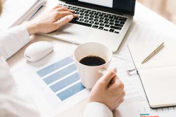 girl looking on monitor and drink hot coffee, businesswoman working portable computer communication...