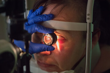 An ophthalmologist checks the fundus of the patient.