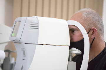 An ophthalmologist checks the fundus of the patient.