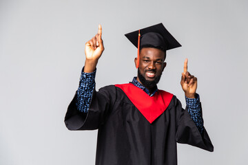 Young graduated african american man cheerful with a smile of face pointing with hand and finger up...